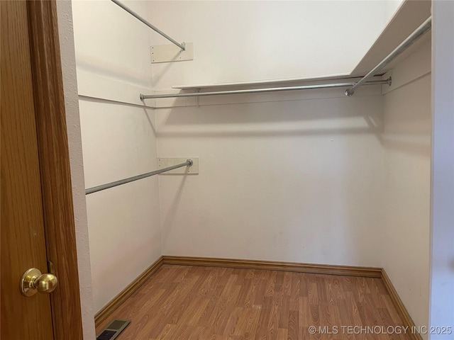 spacious closet with light wood finished floors and visible vents