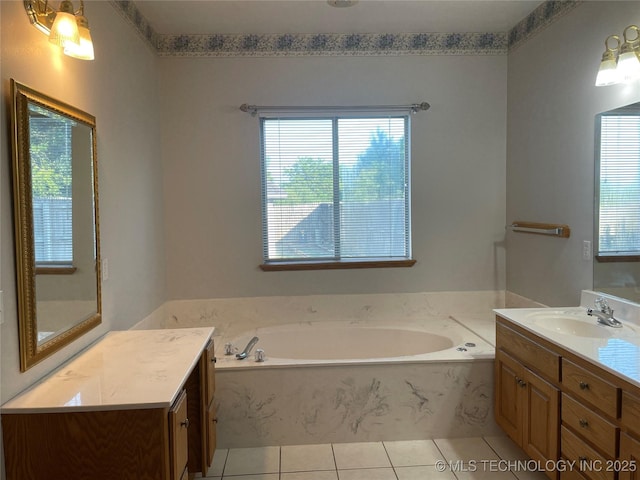 full bath featuring tile patterned flooring, a garden tub, and vanity