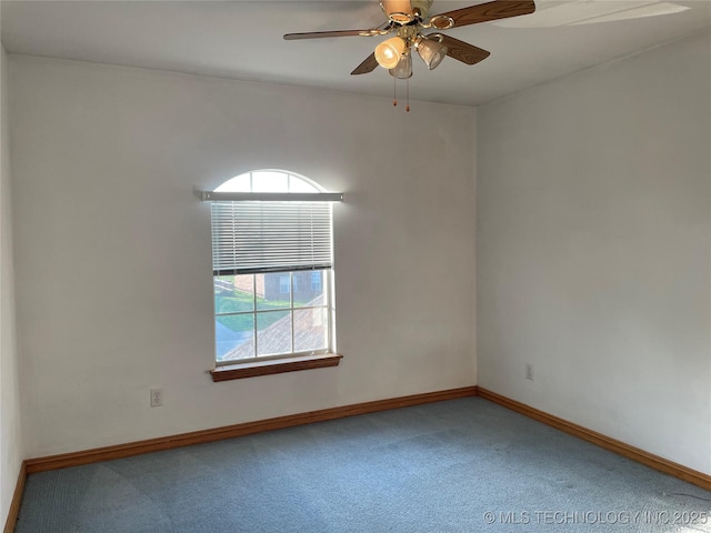 carpeted empty room with ceiling fan, plenty of natural light, and baseboards