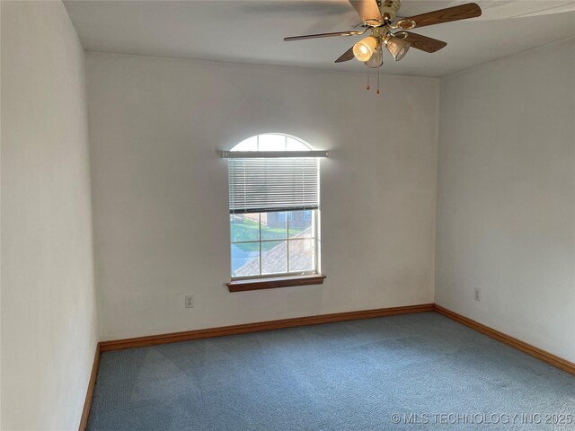 spare room with carpet floors, ceiling fan, and baseboards