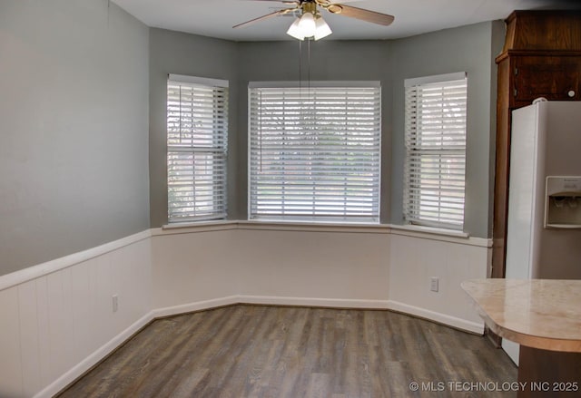 unfurnished dining area with hardwood / wood-style flooring and ceiling fan