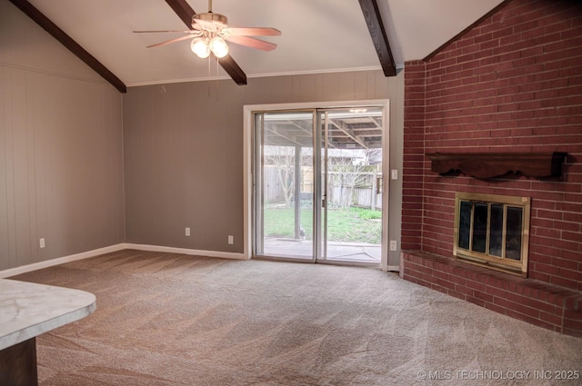 unfurnished living room with a fireplace, carpet floors, lofted ceiling with beams, and ceiling fan