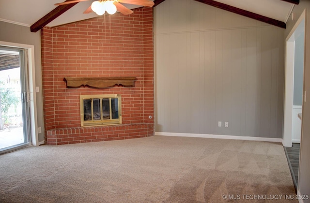 unfurnished living room featuring a brick fireplace, vaulted ceiling with beams, and carpet