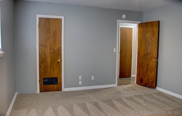 unfurnished room with light carpet