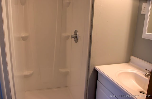 bathroom featuring vanity and walk in shower