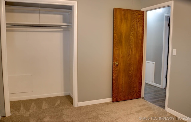 unfurnished bedroom featuring carpet floors and a closet