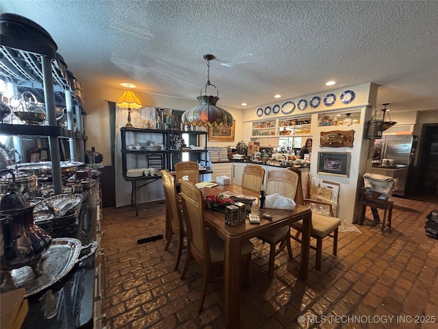 dining space with a textured ceiling