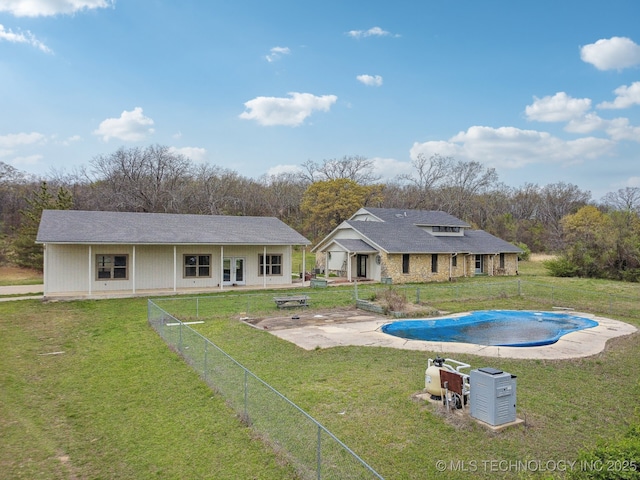 view of swimming pool featuring a patio area, a fenced in pool, and a lawn