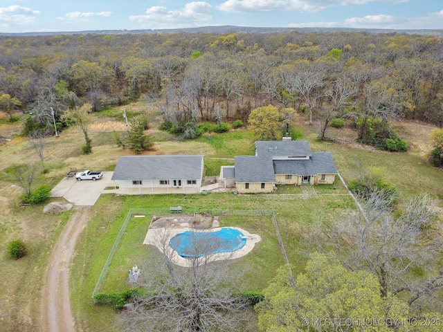birds eye view of property with a forest view