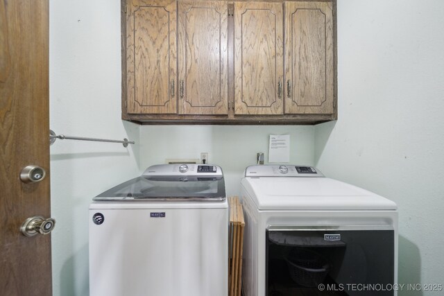 laundry room featuring cabinet space and washing machine and clothes dryer