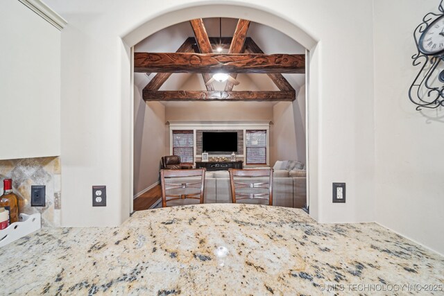 bedroom with vaulted ceiling with beams