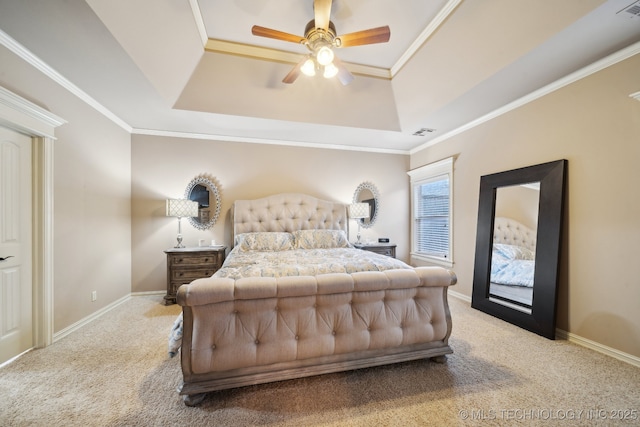 bedroom featuring a raised ceiling, ornamental molding, light colored carpet, and ceiling fan