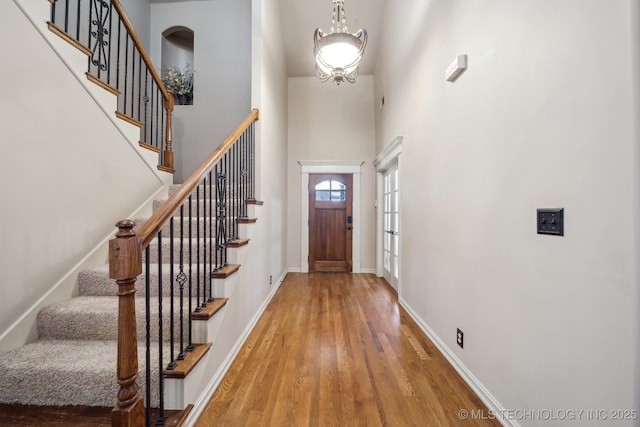 entrance foyer with a high ceiling and hardwood / wood-style floors