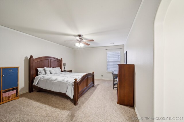 bedroom with ornamental molding, light colored carpet, and ceiling fan