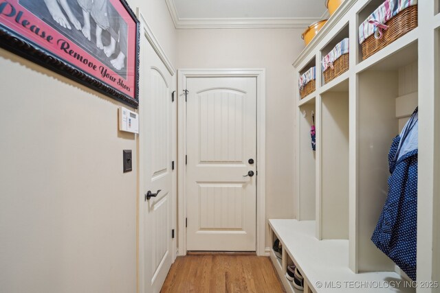 mudroom featuring ornamental molding and light hardwood / wood-style floors