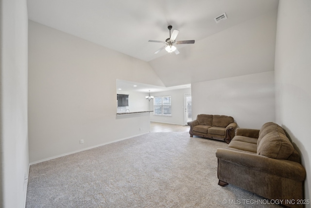 living room featuring lofted ceiling, ceiling fan with notable chandelier, and light carpet