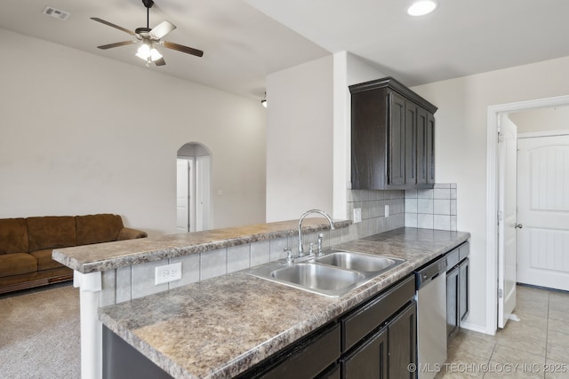 kitchen with sink, dishwasher, ceiling fan, backsplash, and kitchen peninsula