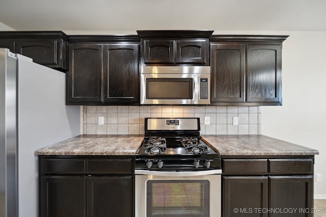 kitchen featuring tasteful backsplash, dark brown cabinets, and appliances with stainless steel finishes