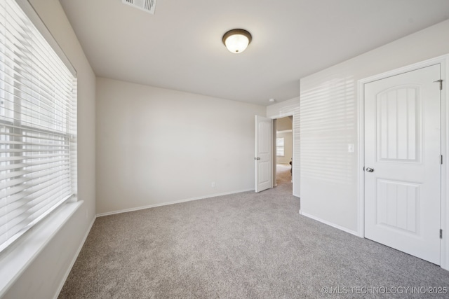 unfurnished bedroom with carpet floors and a closet