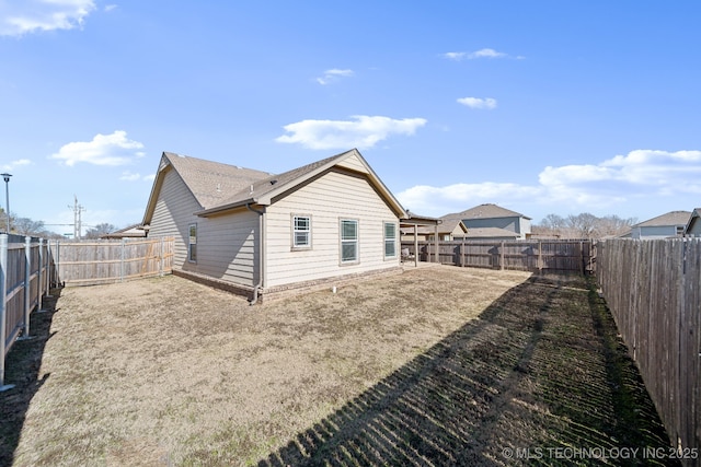 back of house with a lawn