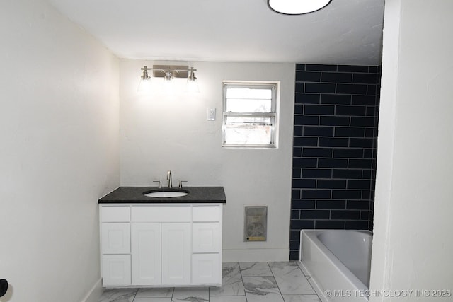 bathroom featuring vanity and tiled shower / bath