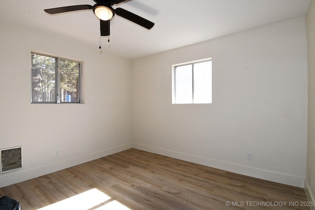 unfurnished room with hardwood / wood-style flooring and ceiling fan