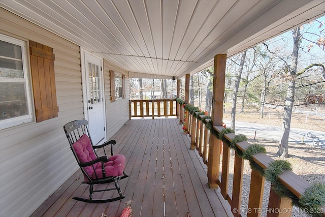 wooden terrace featuring covered porch