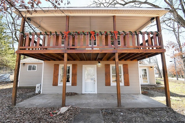 view of front of home with a deck and a patio area