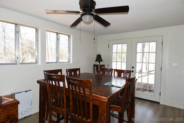 dining space featuring dark wood-type flooring, a wealth of natural light, french doors, and ceiling fan