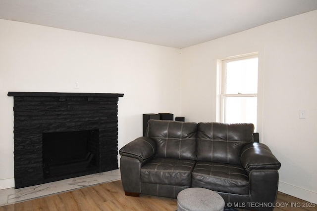 living room featuring hardwood / wood-style flooring and a fireplace