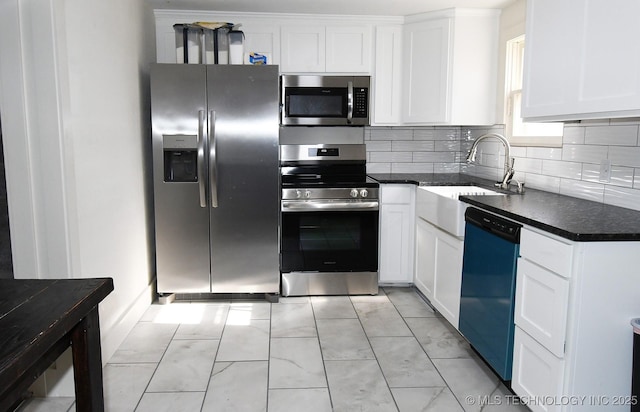 kitchen featuring white cabinetry, appliances with stainless steel finishes, sink, and tasteful backsplash