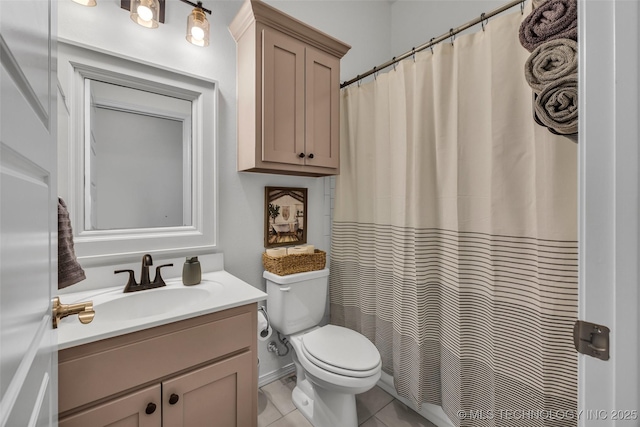 bathroom featuring tile patterned flooring, vanity, and toilet