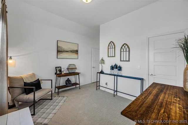 sitting room featuring light colored carpet