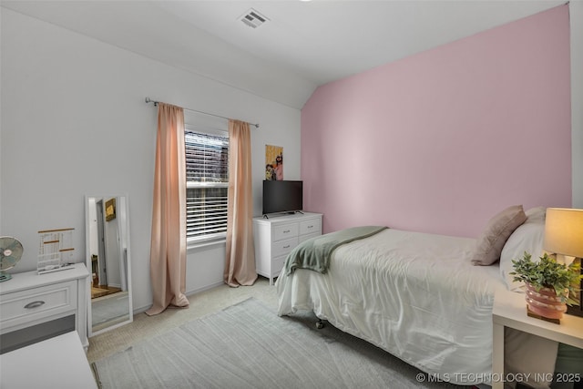 carpeted bedroom featuring lofted ceiling