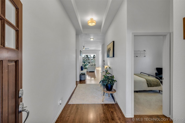 corridor with hardwood / wood-style flooring