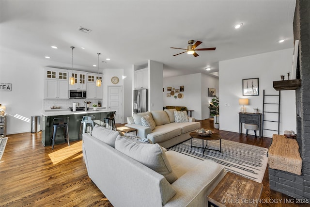 living room with ceiling fan and light hardwood / wood-style floors