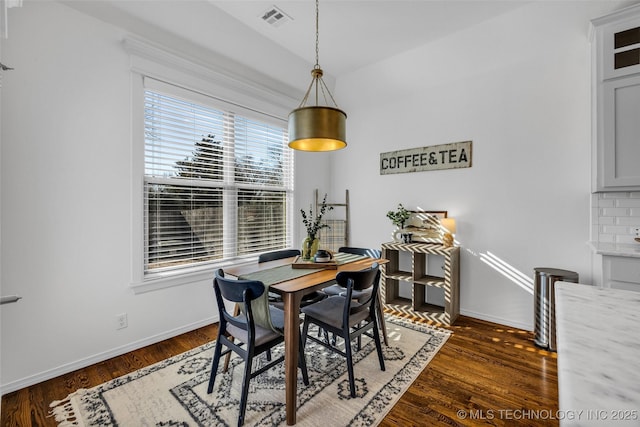 dining area with dark hardwood / wood-style floors