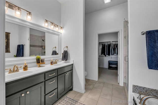 full bathroom with toilet, vanity, plus walk in shower, and tile patterned flooring