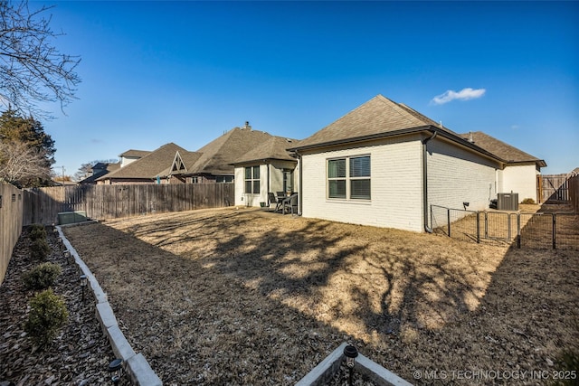 rear view of property featuring central AC