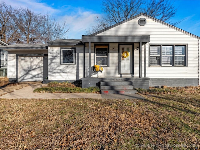 single story home featuring a garage, covered porch, and a front lawn