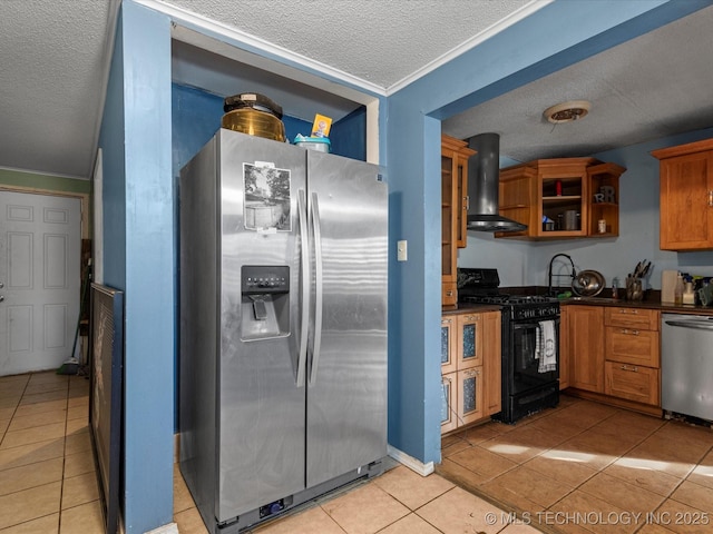 kitchen with island exhaust hood, stainless steel appliances, a textured ceiling, and light tile patterned floors