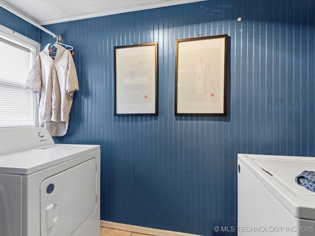 laundry area featuring separate washer and dryer and a textured ceiling