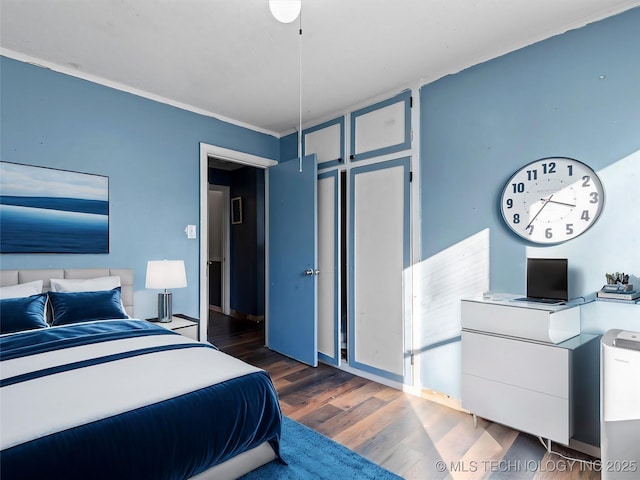 bedroom with dark wood-type flooring