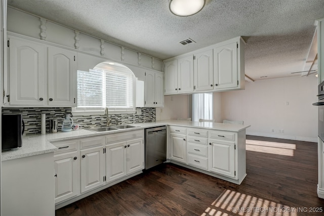 kitchen with white cabinetry, dishwasher, sink, and kitchen peninsula