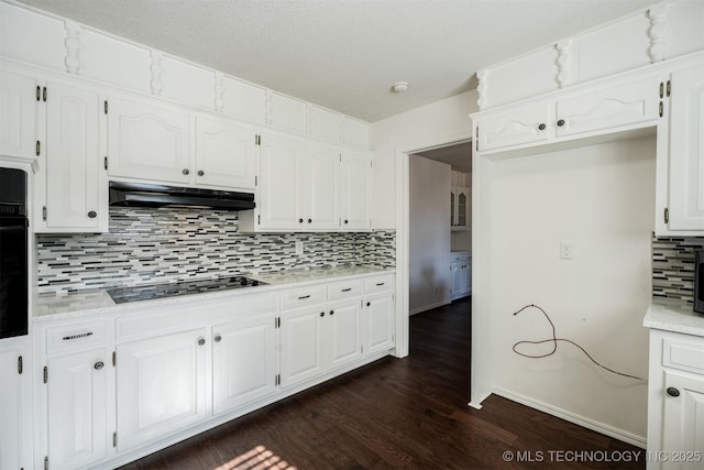 kitchen with tasteful backsplash, white cabinetry, dark hardwood / wood-style floors, and black appliances