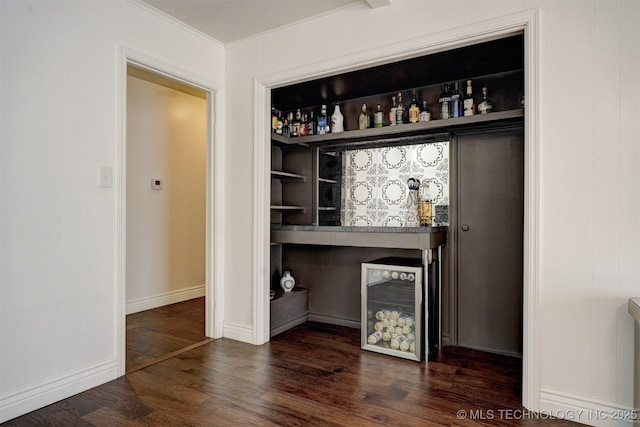 bar with dark wood-type flooring and ornamental molding