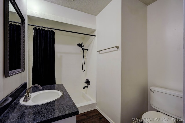 bathroom with a shower with shower curtain, vanity, wood-type flooring, a textured ceiling, and toilet