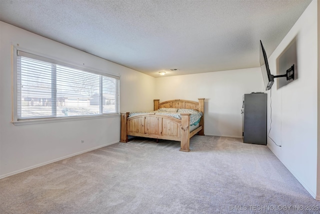 carpeted bedroom featuring a textured ceiling