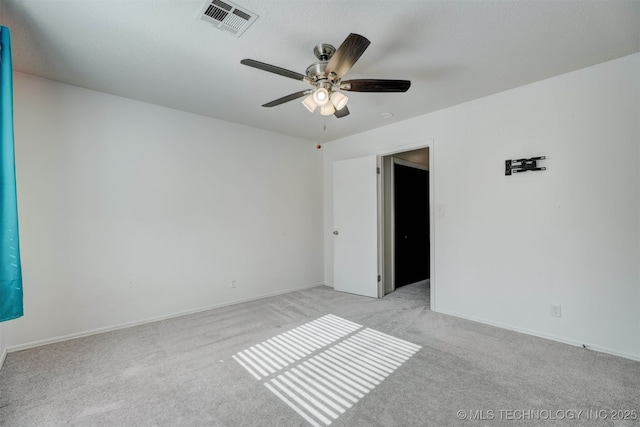 carpeted spare room featuring ceiling fan