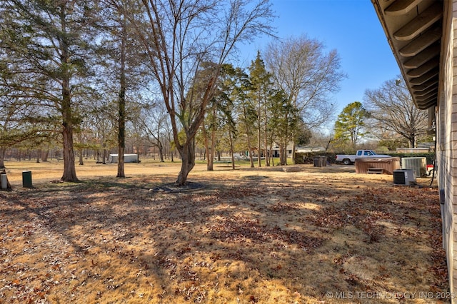 view of yard with a jacuzzi and central AC